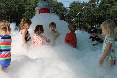 Kids love a Super E Foam Machine at a backyard party